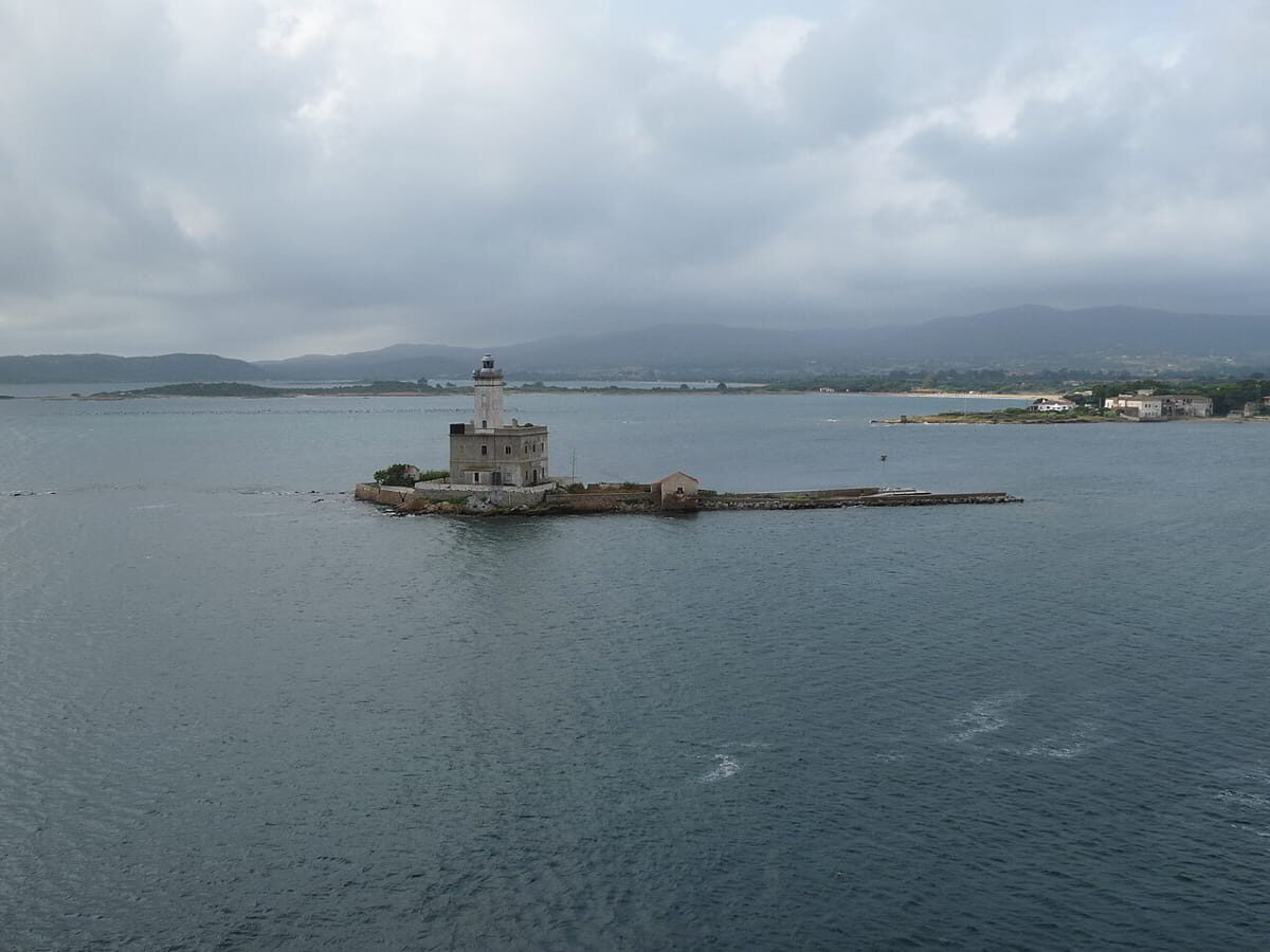 Scenic sunset over the Gulf of Olbia, showing an islet with the old lighthouse in the in Costa Smeralda’s southern gateway