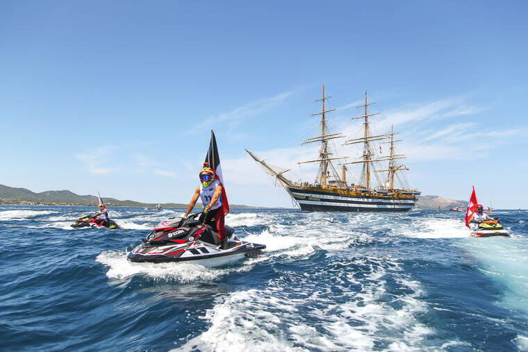 The famous sailing ship Amerigo Vespucci surrounded by jet skis in Olbia