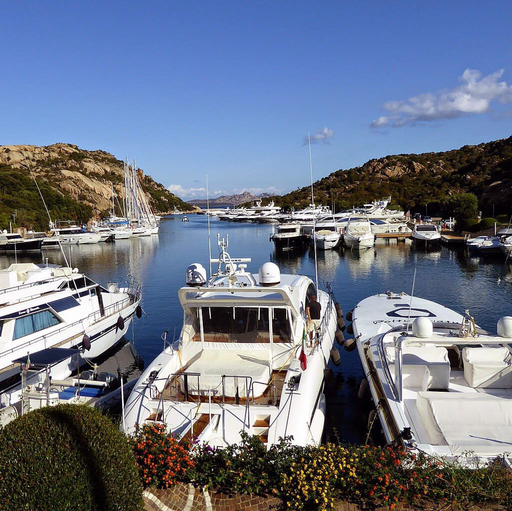 Luxury yachts docked at Poltu Quatu Marina, a boutique mooring spot in Costa Smeralda, Northern Sardinia