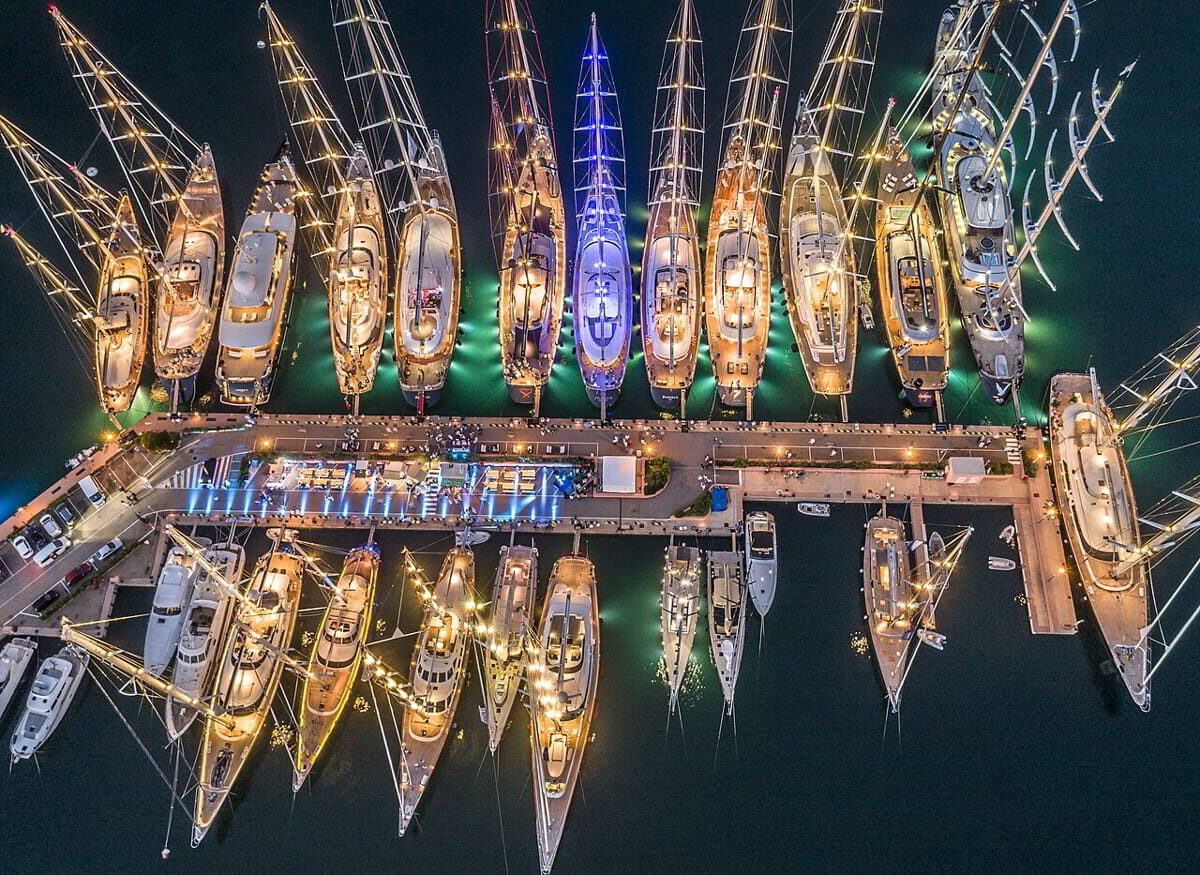 Aerial night view of Porto Cervo Marina with luxury yachts moored along the dock in Costa Smeralda, Sardinia