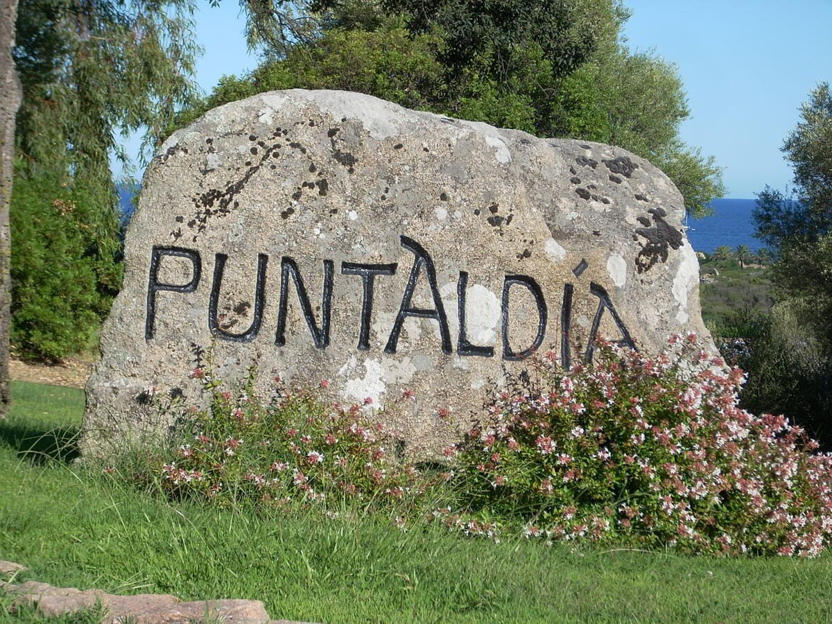 Granite stone with Puntaldia inscription marking the entrance to the marina area in North East Sardinia