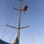 Yacht rigging system being inspected and renewed by technician in Costa Smeralda marina