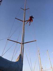 Yacht rigging system being inspected and renewed by technician in Costa Smeralda marina