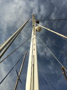 Yacht rigging system being inspected and renewed by technician in Costa Smeralda marina