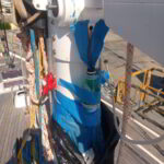 Detailed view of deck hardware components being maintained on sailing yacht in Marina di Olbia