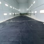 Large sail laid out and cleaned with low-pressure water jets by yacht service team