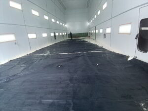 Large sail laid out and cleaned with low-pressure water jets by yacht service team