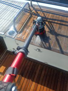 Marine-grade teak treatment being applied to yacht deck in Costa Smeralda